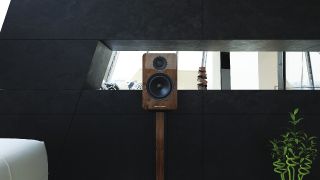 Acoustic Energy AE1 Active speaker on stand in a dark, moody interior