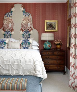 Colorful bedroom with pattern and ornate headboard