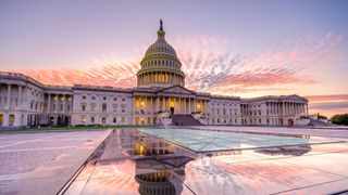 An image of the US Capitol building with the sunset in the background