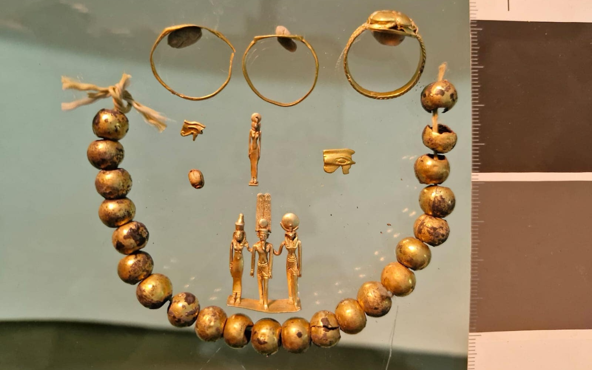 A collection of Egyptian gold jewelry and figurines