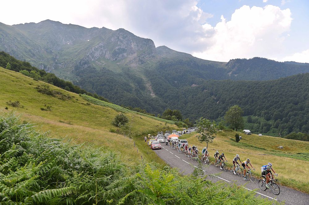 The peloton rides through the mountains during stage 12.