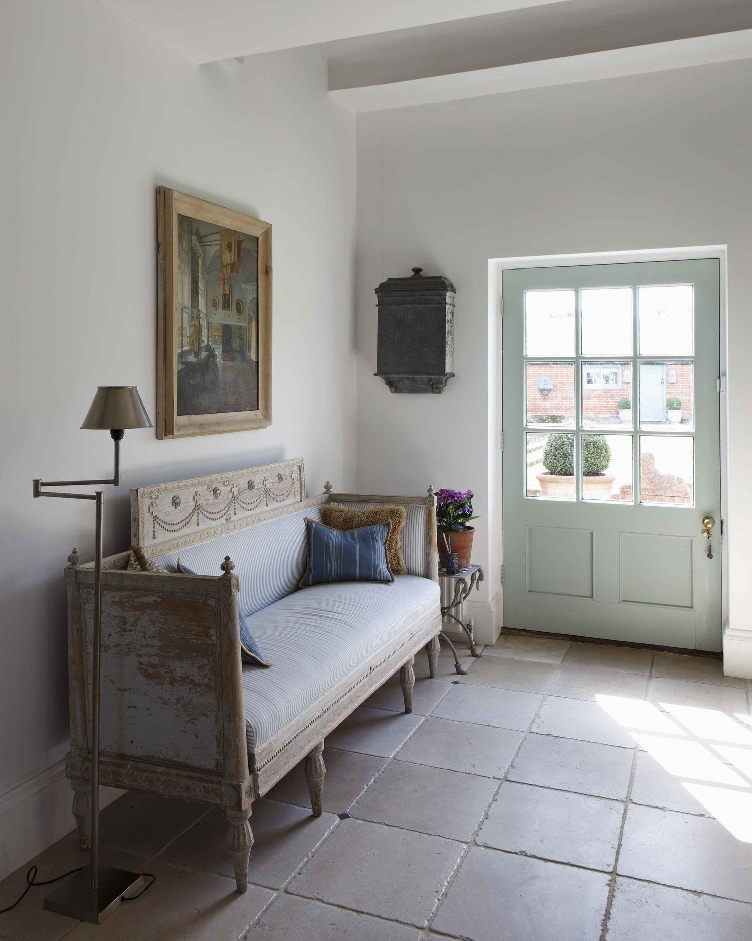 Hallway with stone flooring and side light
