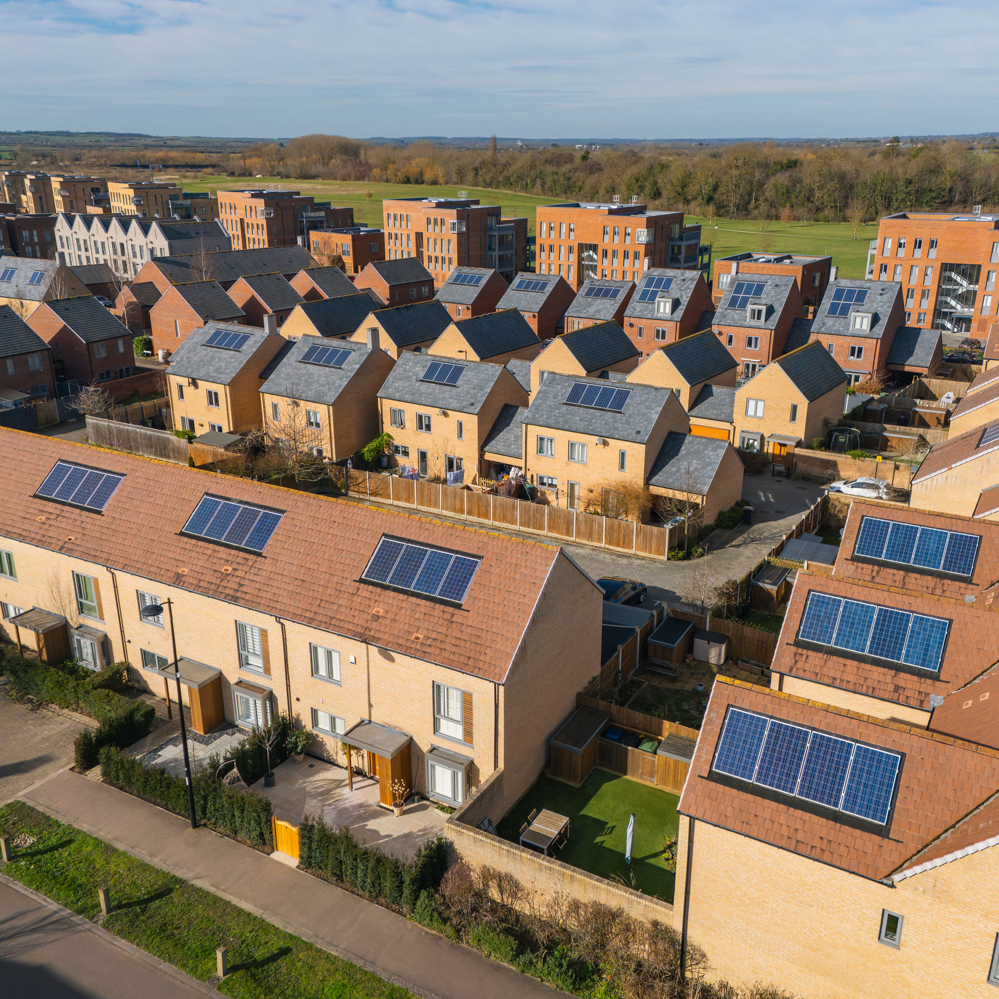 Solar panel on the roofs of an estate in the UK, next to fields