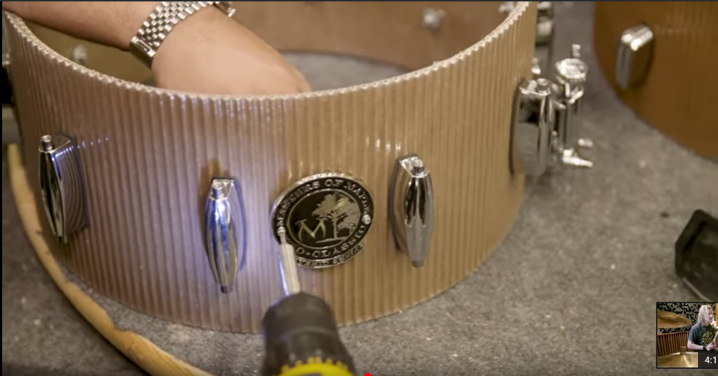 Cardboard snare drum being fitted with hardware by Masters Of Maple