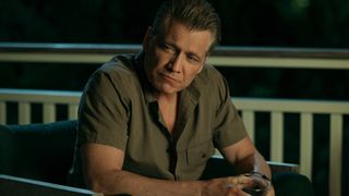 Holt McCallany sitting with a drink in The Waterfront