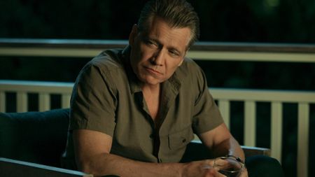 Holt McCallany sitting with a drink in The Waterfront