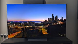 LG C5 with landscape shot of city at night on screen