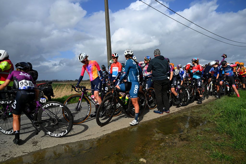 DE PANNE BELGIUM MARCH 23 The peloton stops because the race has been neutralised after the accident in the 6th Exterioo Womens Classic BruggeDe Panne 2023 a 1631km one day race from Brugge to De Panne UCIWWT on March 23 2023 in De Panne Belgium Photo by Luc ClaessenGetty Images