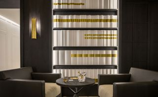 Hexagone "Bookshelf" wall feature with 2 low single leather couches
