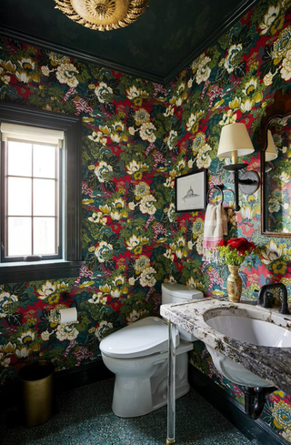 Colorful powder room with bold wallpaper in green and red
