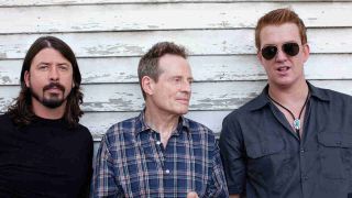 Them Crooked Vultures posing for a photograph in 2009