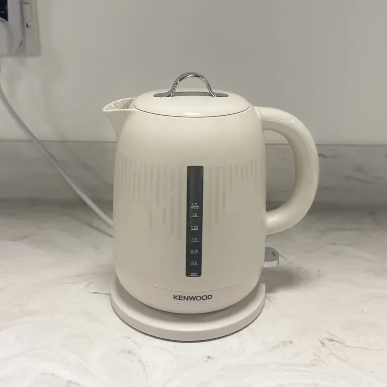 Testing a cream Kenwood kettle which sits on a marble countertop