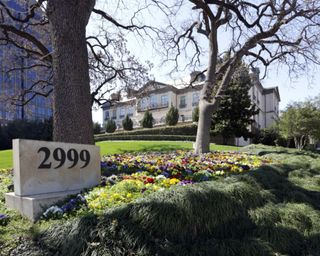 grand mansion home exterior with large front gardens