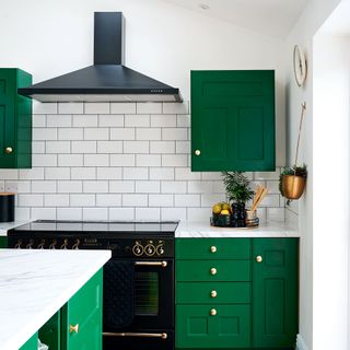 kitchen with white walls and white brick white tiles wall with green cabinet and white marble countertop and microwave
