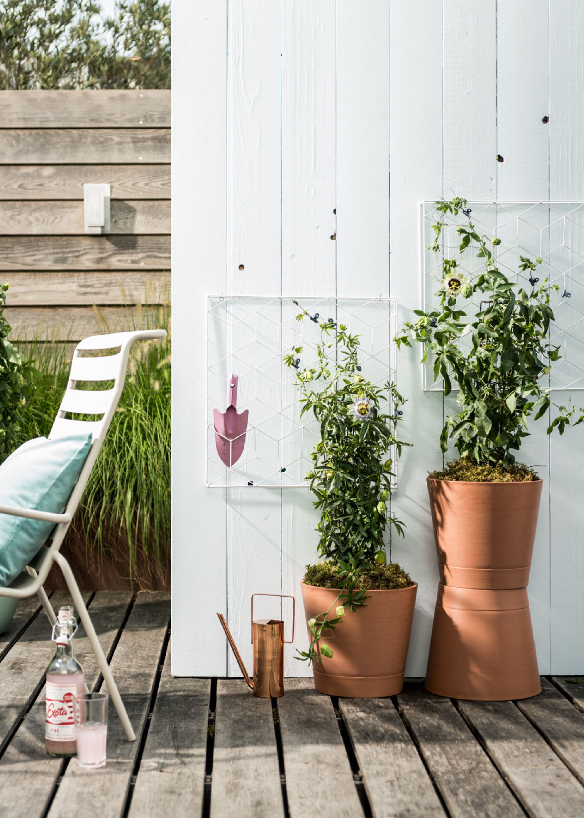 An outdoor deck with a pair of potted plants