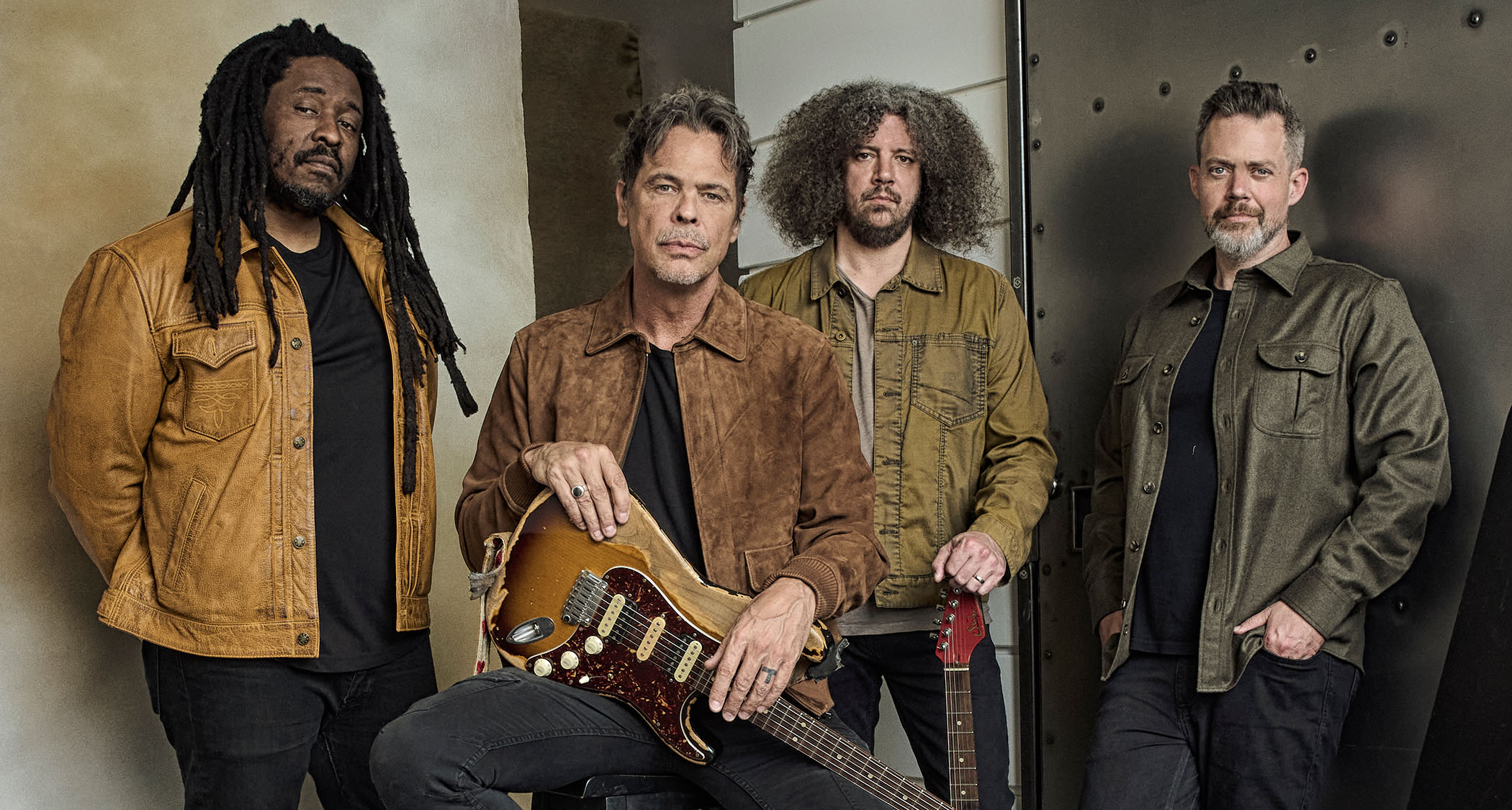 Big Wreck post for a band photo with Ian Thornley holding his Suhr electric guitar