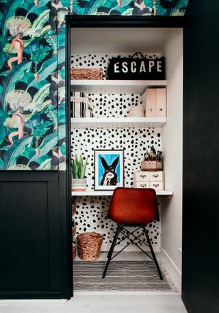 DIY desk area with floating shelves and bold wallpaper