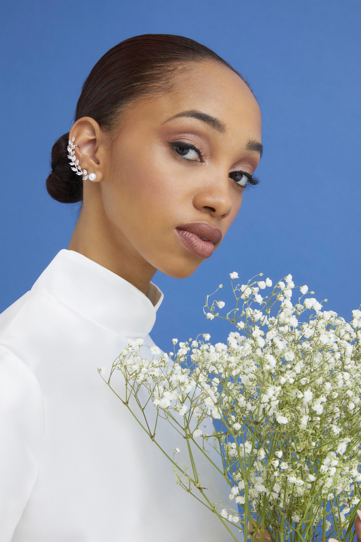 A model showing off a slicked-back wedding hairstyle.