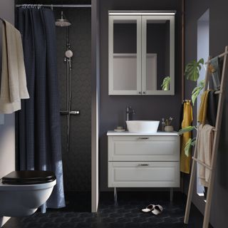 small bathroom with a dark color scheme from ikea