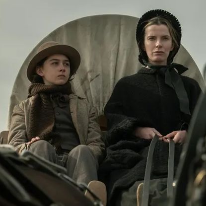 preston mota and betty gilipin as a mother and son riding on a wagon in the tv show american primeval