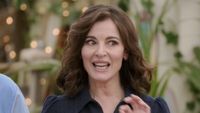 Nigella giving instructions in a blue dress in the trailer for Bake Off.