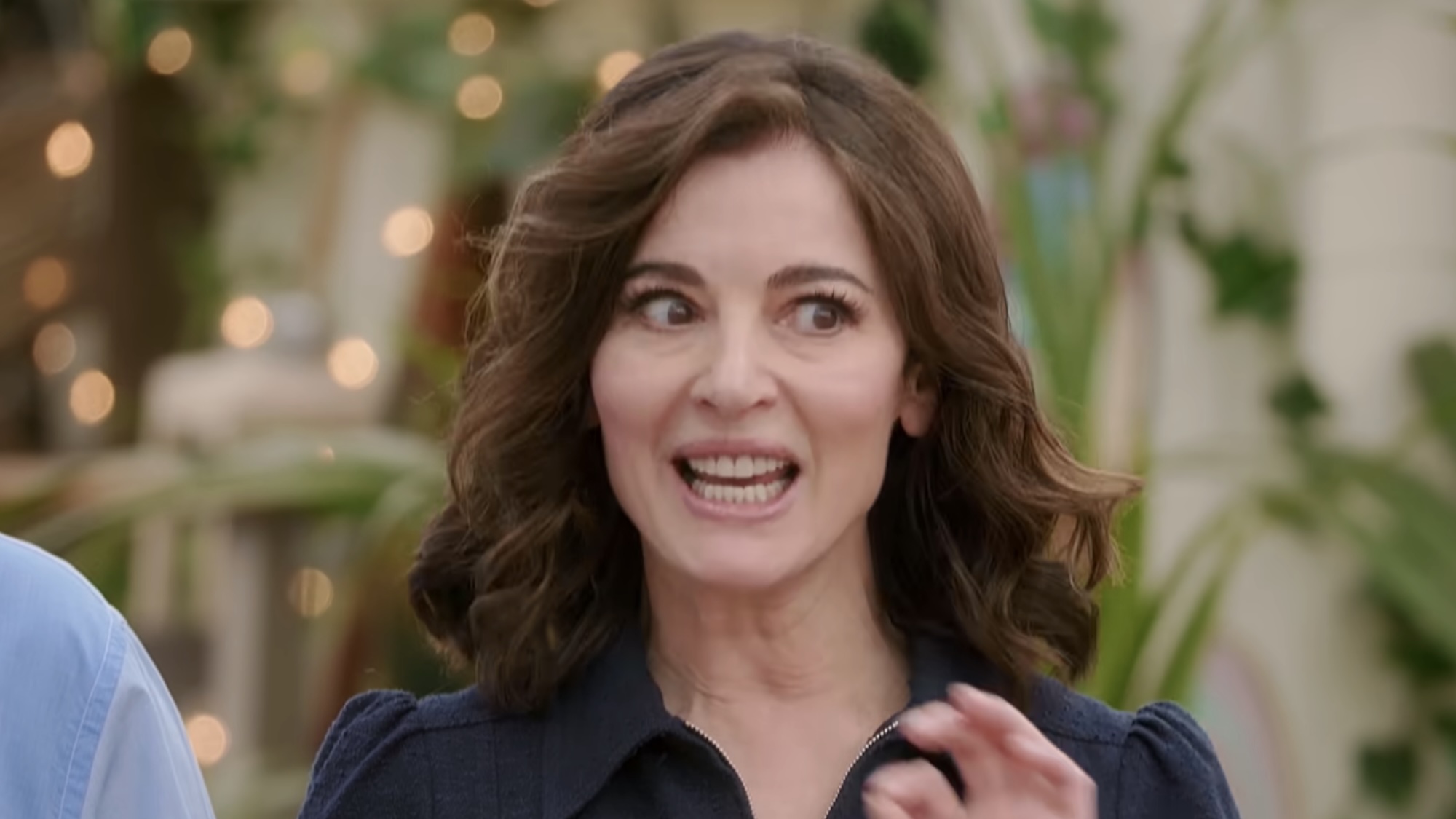 Nigella giving instructions in a blue dress in the trailer for Bake Off.