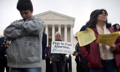 Anti-abortion activists lead a prayer vigil outside the Supreme Court on March 25: The GOP is poised to adopt as part of its platform a vow to ban abortion even in cases of rape or incest.