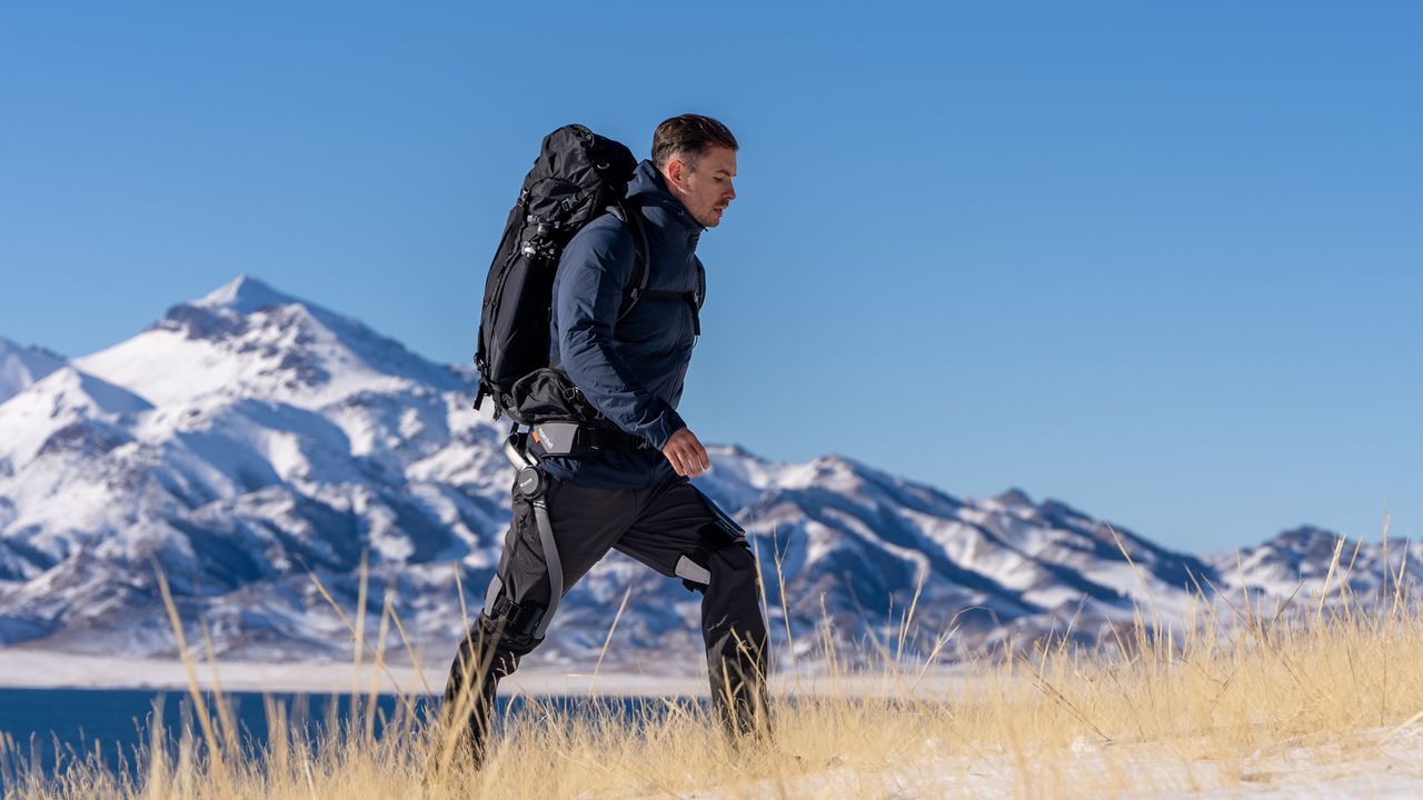 A man hiking in the mountains using a Hypershell exoskeleton