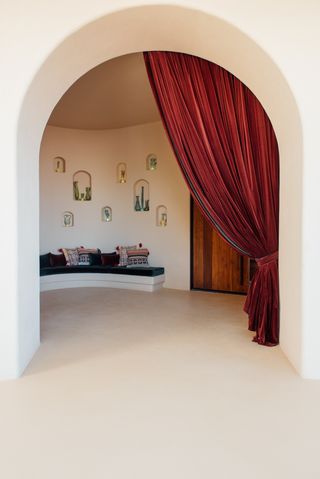 entrance to six senses shaharut in israel, arched doorway and colourful pillows in background