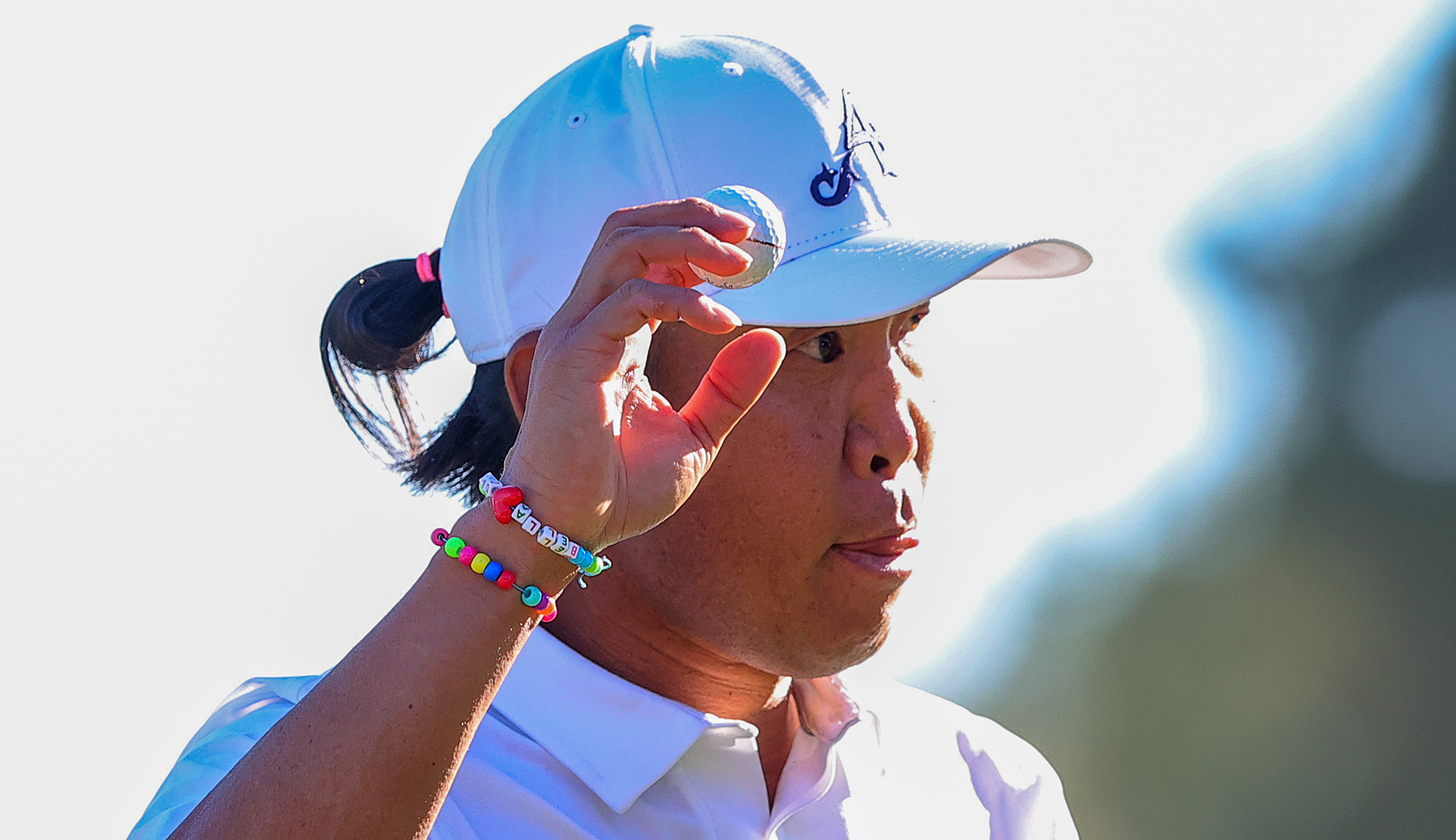 Anthony Kim waves his hand in the air