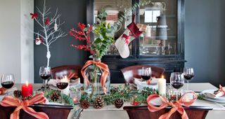Christmas dining table with oversized vase filled with red berries and eucalyptus