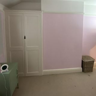 room with white door and pink walls
