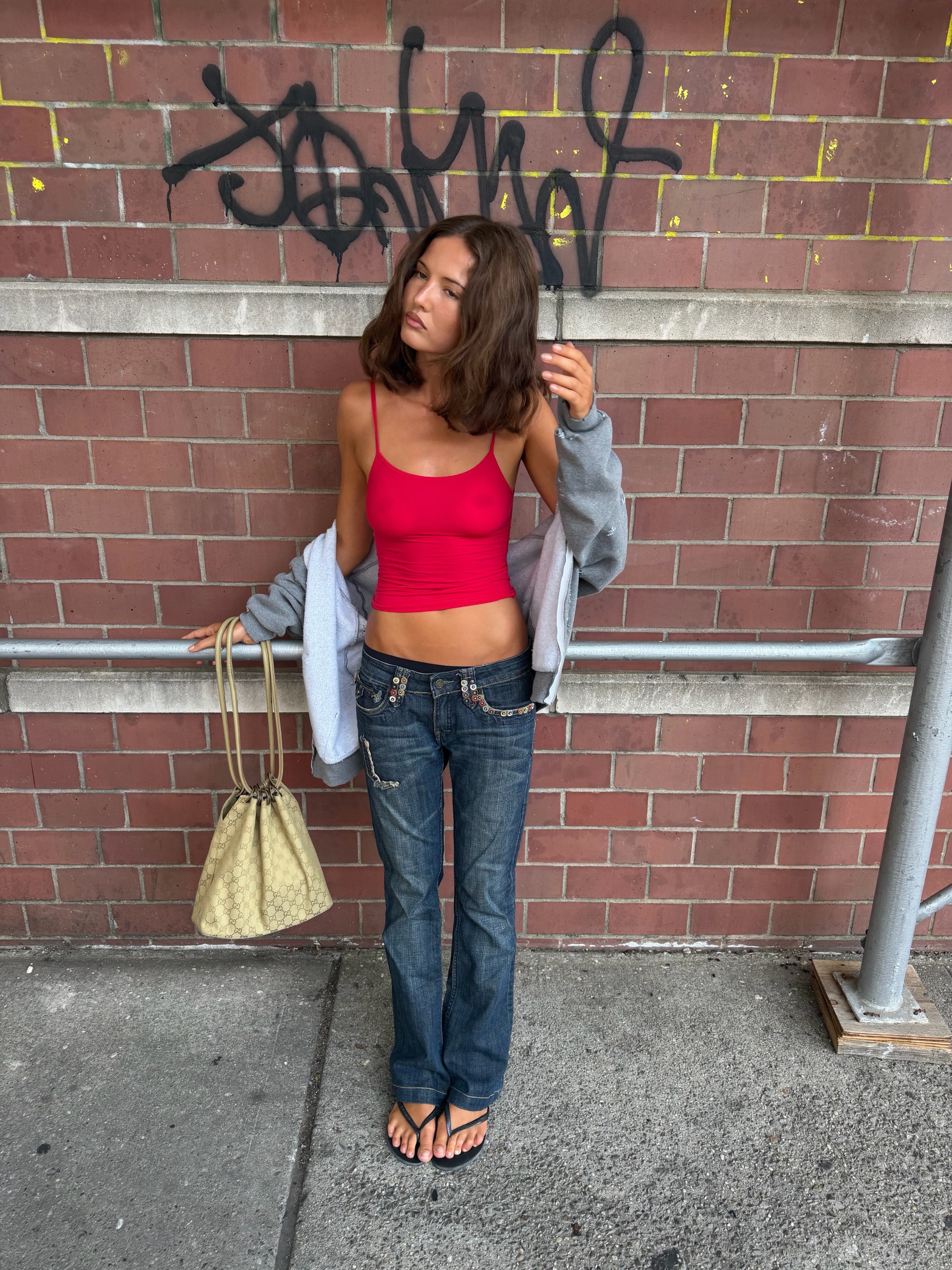 A woman wearing low rise bootcut jeans in 2026.