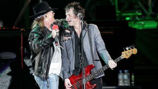 Axl Rose and Tommy Stinson of Guns N' Roses performs following the V8 Supercar Grand Finale at ANZ Stadium on December 4, 2010 in Sydney, Australia.