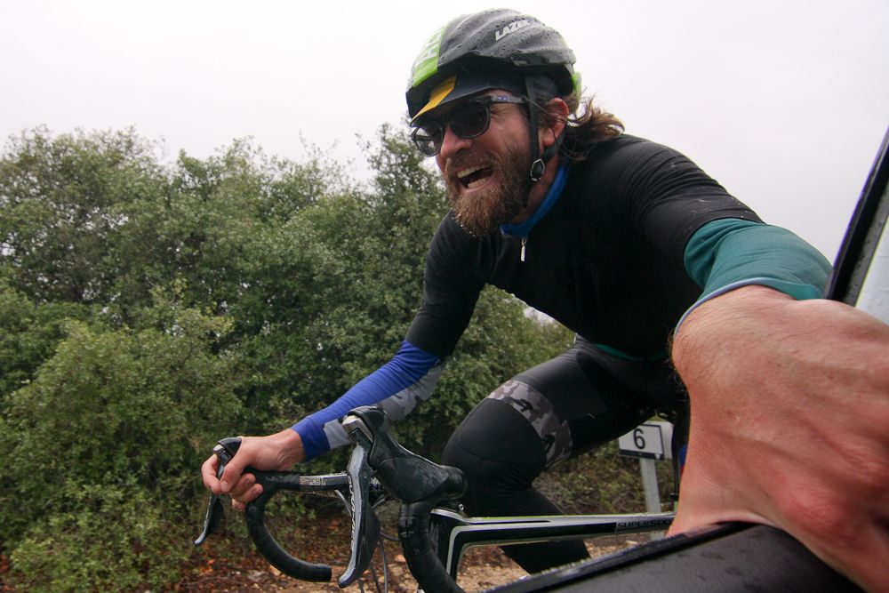Dan Craven gets a lift from the team car.