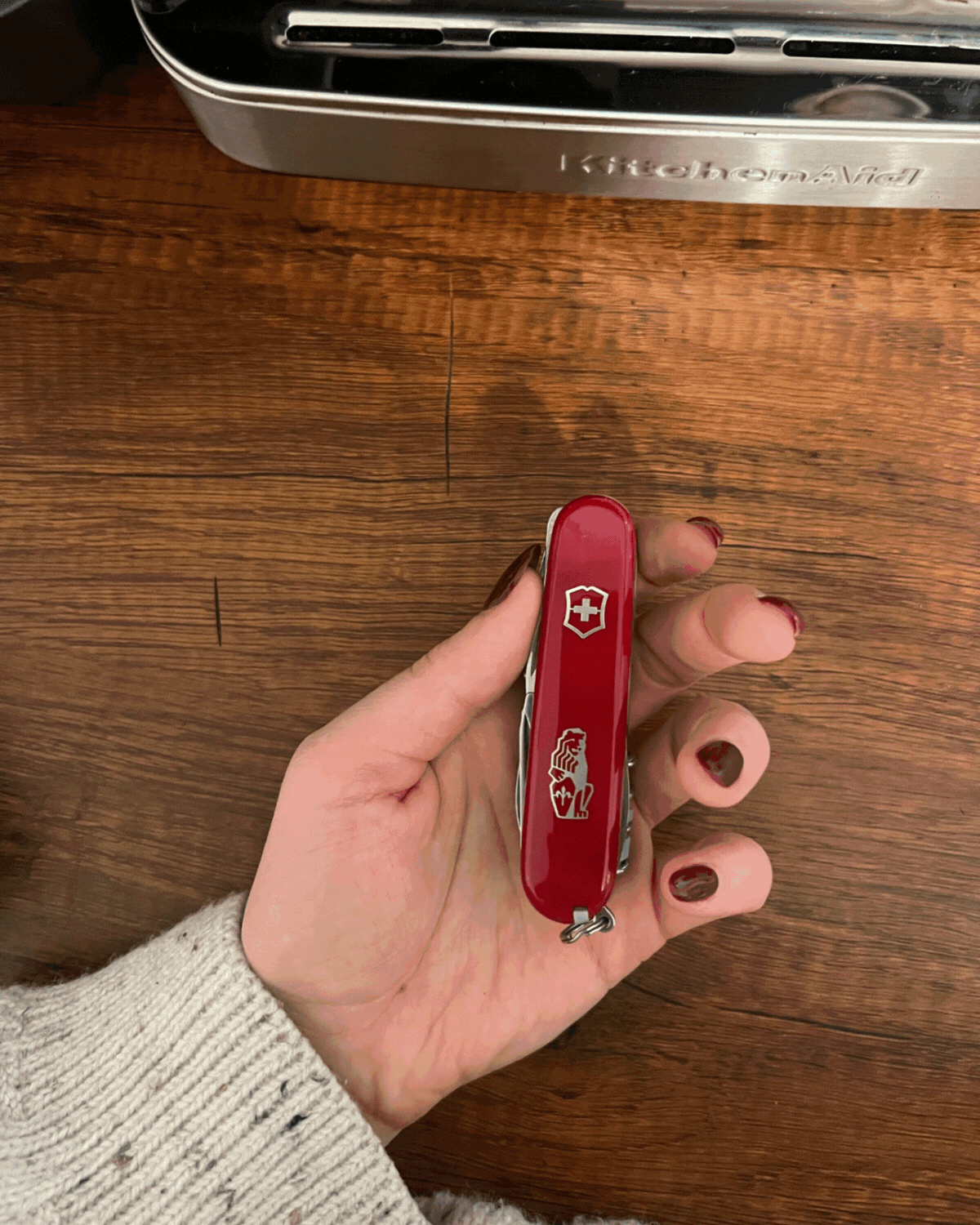 Rotating GIF of the Victorinox x La Marzocco barista tool with different elements of it pulled out to showcase what it does.