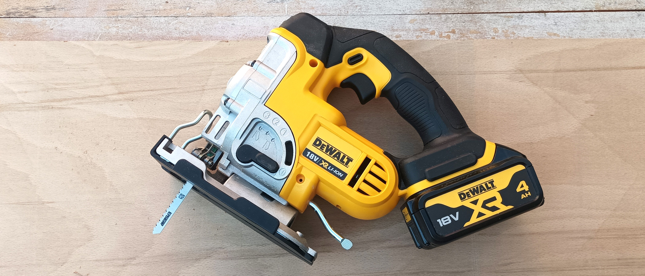 DeWaltDCS331N cordless jigsaw on plywood background