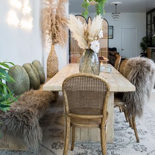 dining room with wooden dining table and woven dining chairs