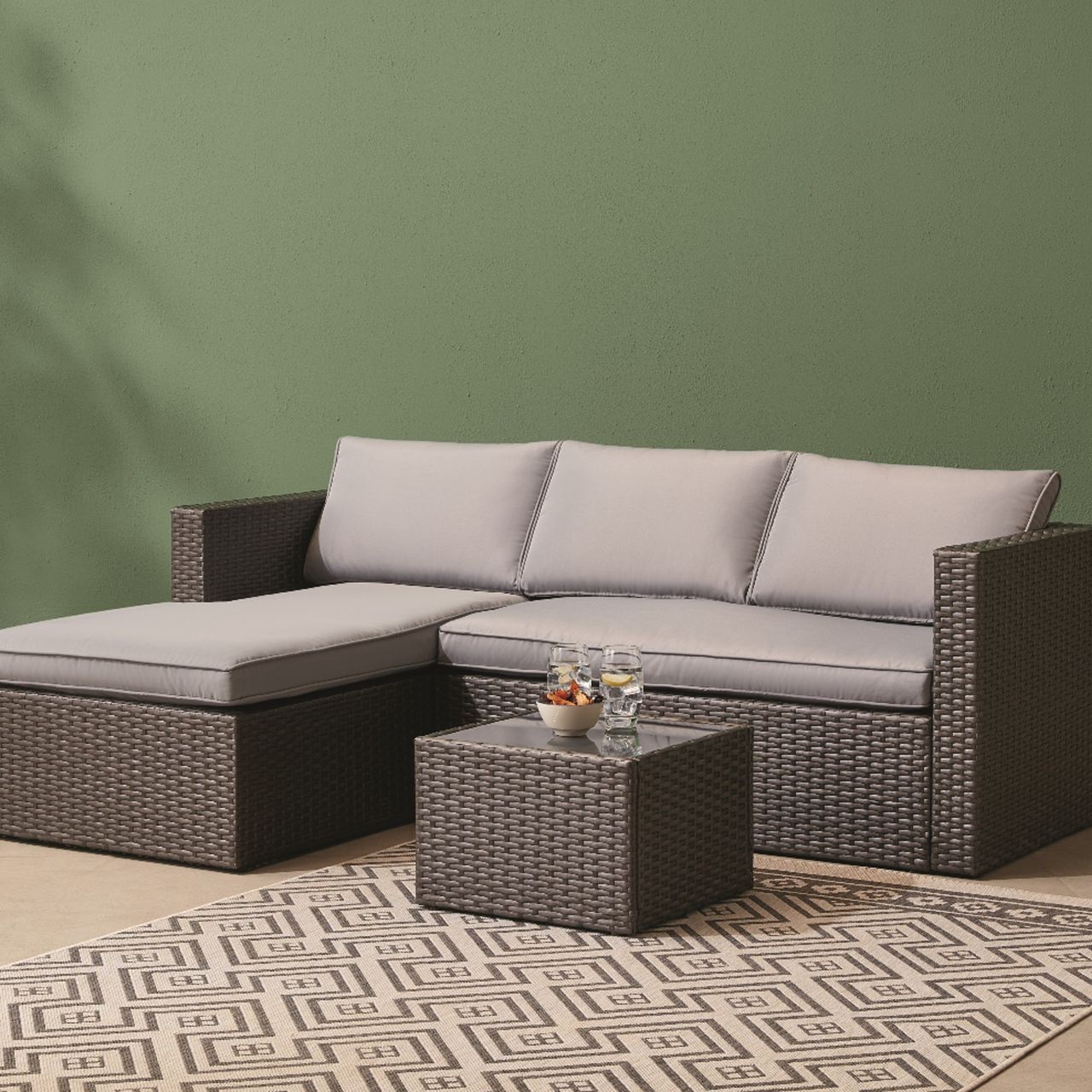 Tesco Outdoor Living corner sofa against a green background