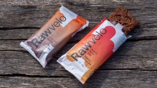 A pair of rawvelo energy bars on a wooden bench