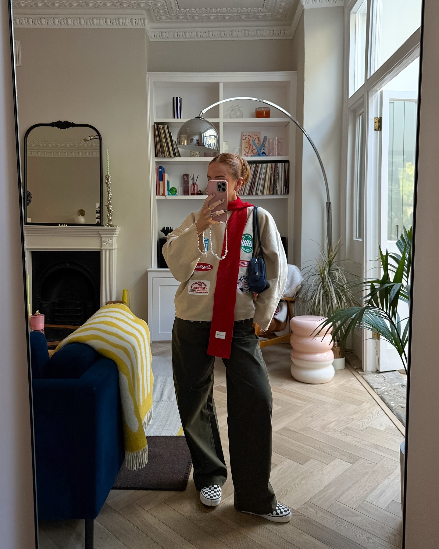 Fashion person Rebecca Ferraz Wyatt wears the checkered vans slip on trainers trend. She wears them with khaki trousers.