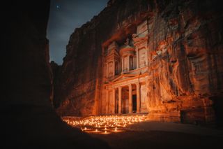Petra is surrounded by candles making it glow in the night