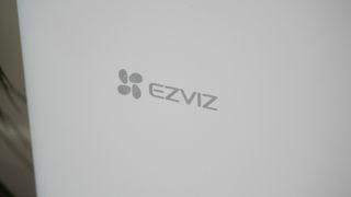 The EZVIZ RE4 Plus robot vacuum in a carpeted living room