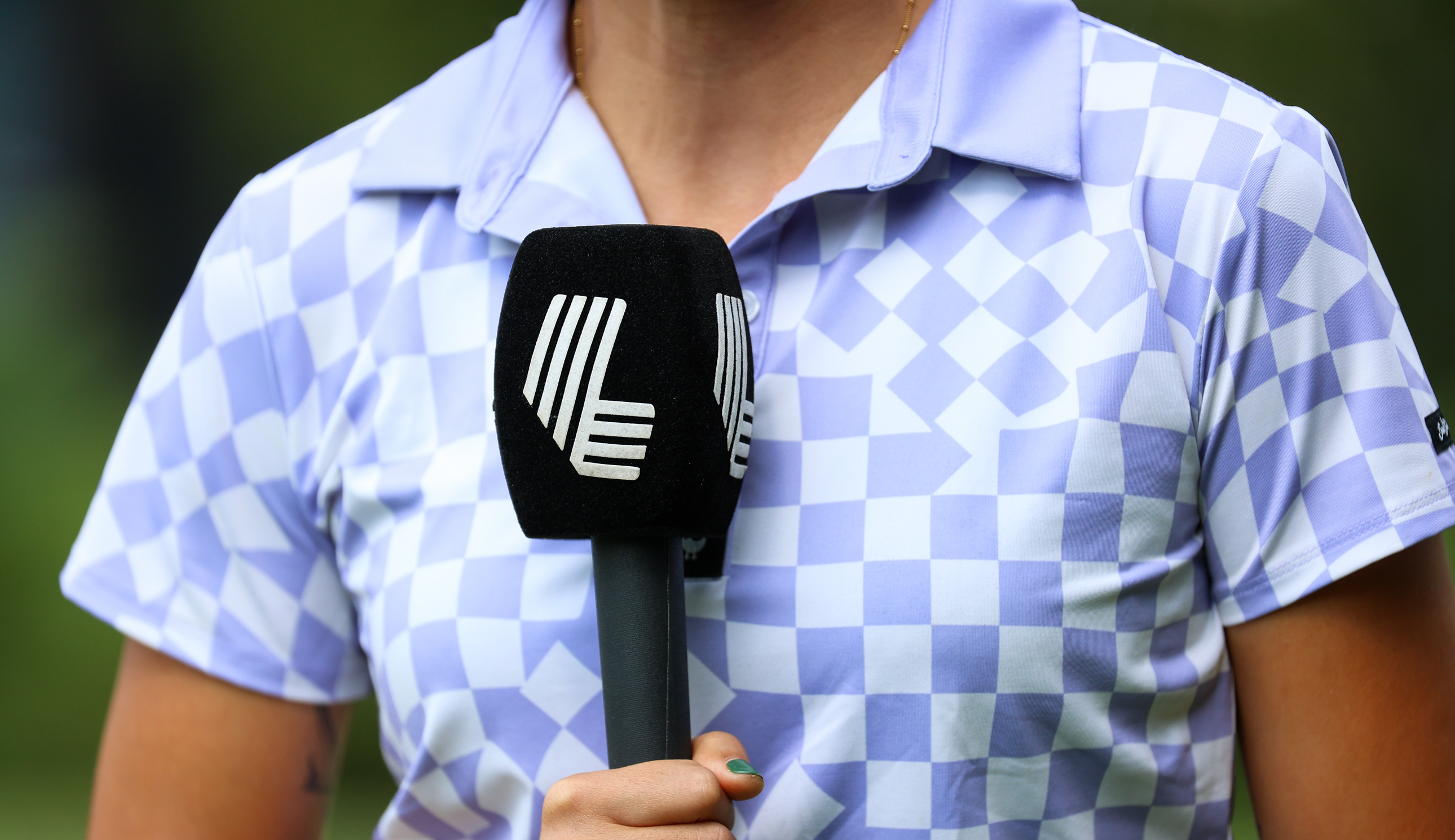 A LIV Golf microphone held