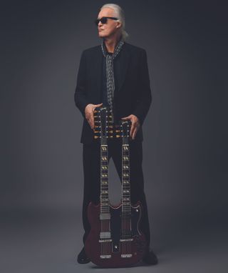 Jimmy Page poses for Gibson with his Gibson Jimmy Page EDS-1275 double-neck guitar