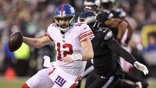 Action shot of New York Giants quarterback Davis Webb slipping past Haason Reddick of the Philly Eagles, ahead of the crucial NFL Playoff Game – Eagles vs Giants