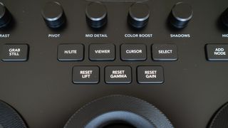Close up of the buttons on a Blackmagic Design DaVinci Resolve Micro Color Panel on a wooden surface