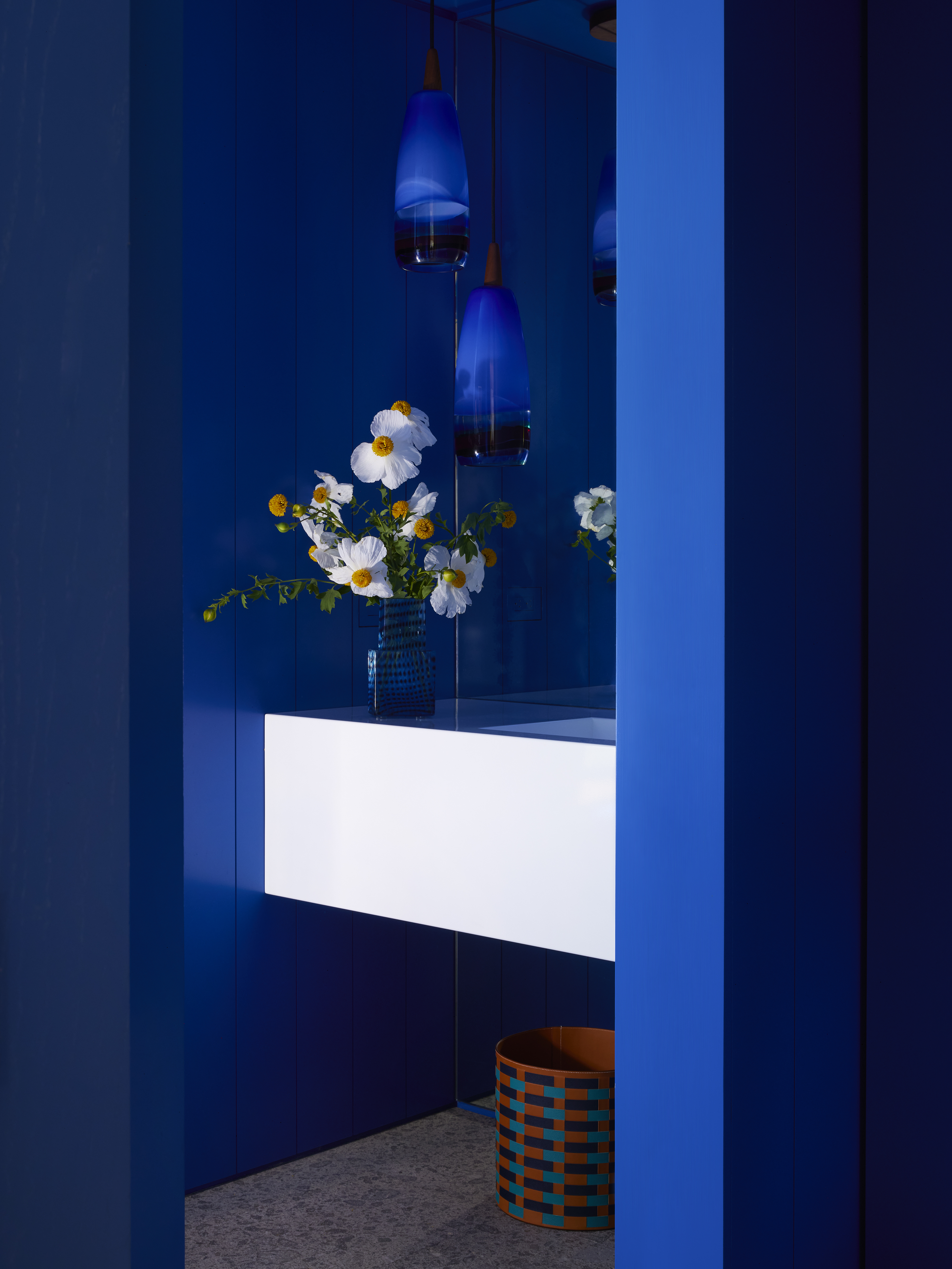 A bathroom painted in deep tones of cobalt blue