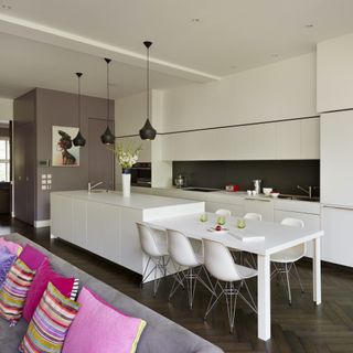 white kitchen with wooden flooring and split level
