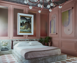 Pink bedroom with grey accents and statement modern lighting